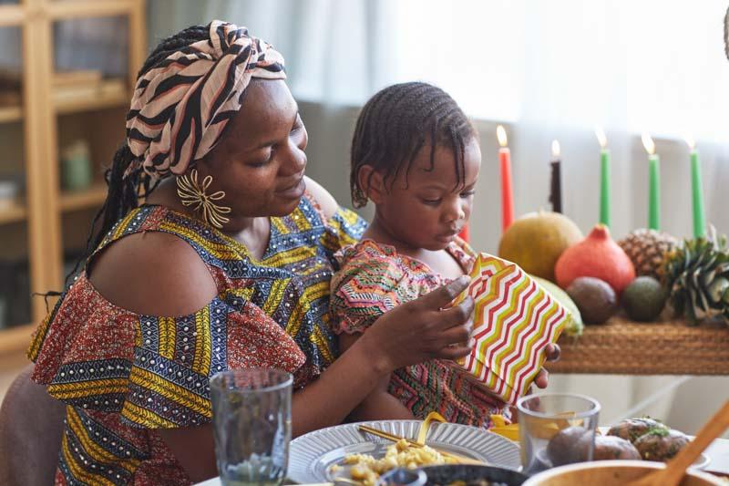 Mom opening gift with her child